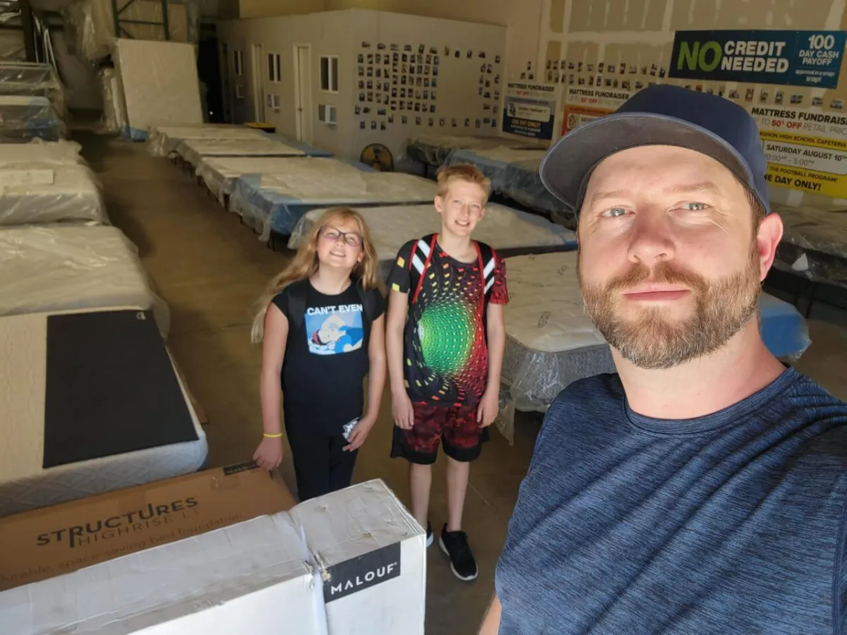 an image of the store owner and his children in the mattress showroom