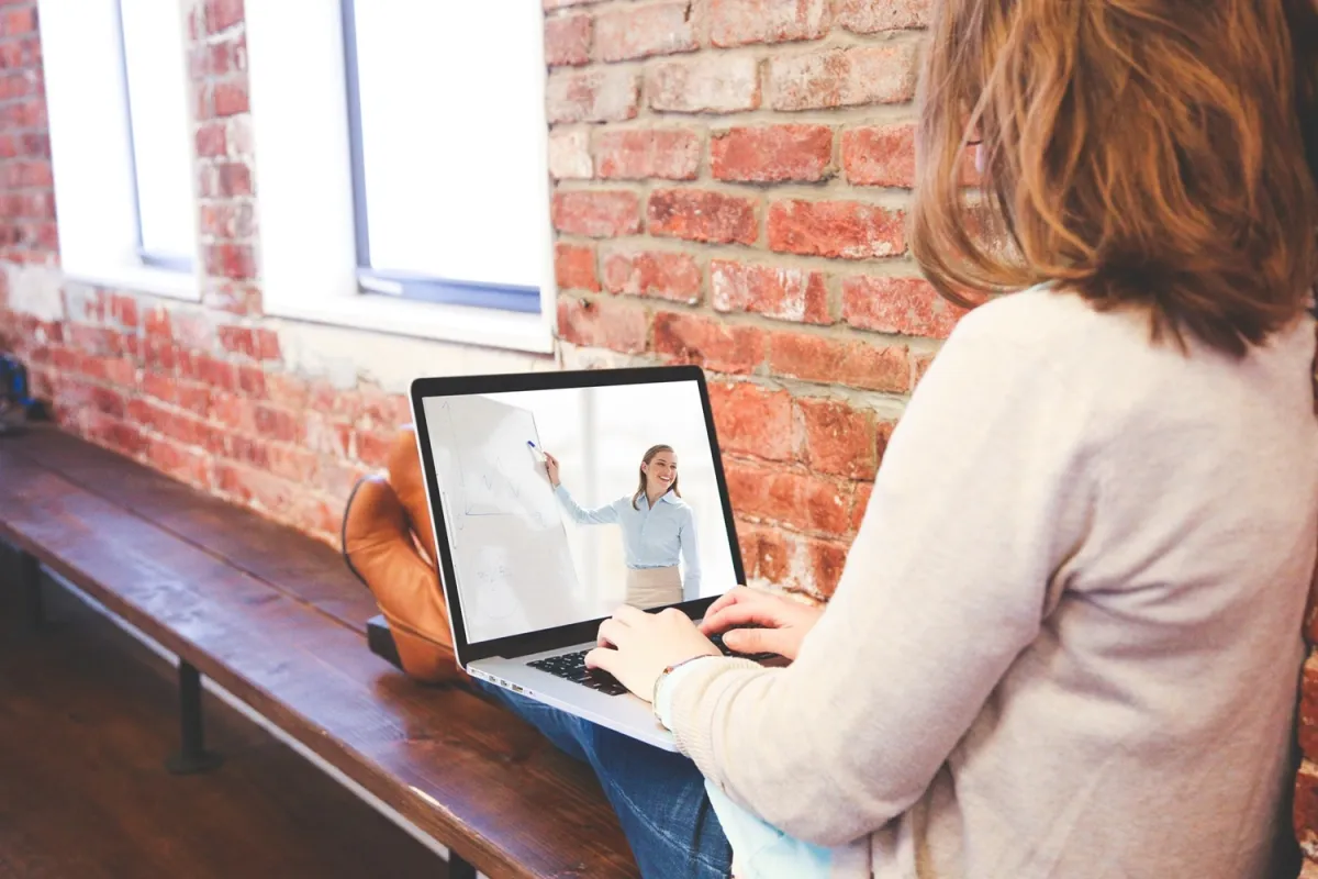 Woman attending an online marketing strategy webinar on a laptop.