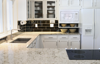 White kitchen cabinets with dark countertops