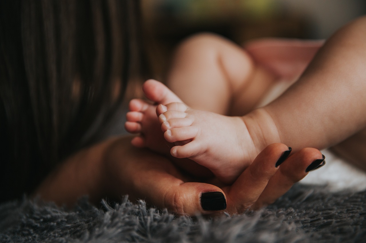 Mother olding baby's feet