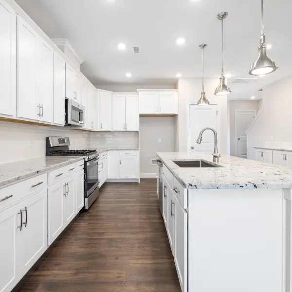 Spacious remodeled kitchen with granite countertops shaker cabinets hardwood floors and stainless steel appliances designed for modern family living