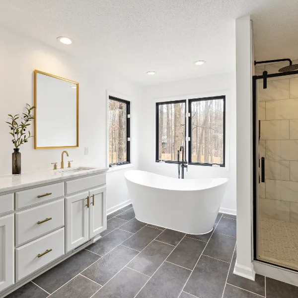 Luxury bathroom remodel with freestanding soaking tub walk in shower custom vanity and tile flooring completed by expert remodelers