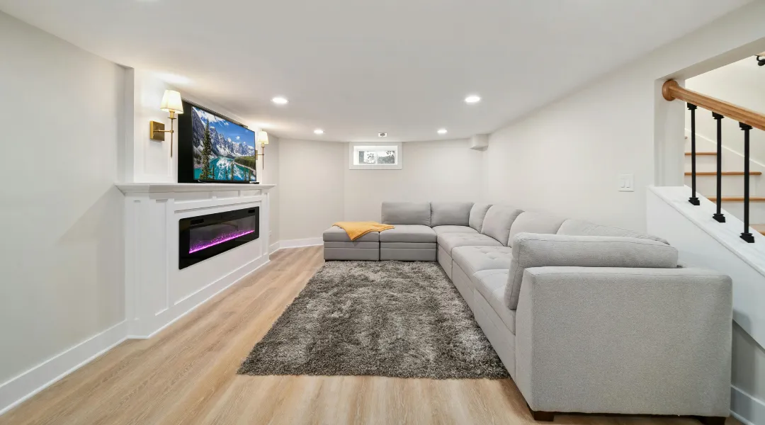 Modern staircase renovation with wooden steps, white risers, and sleek railing design.