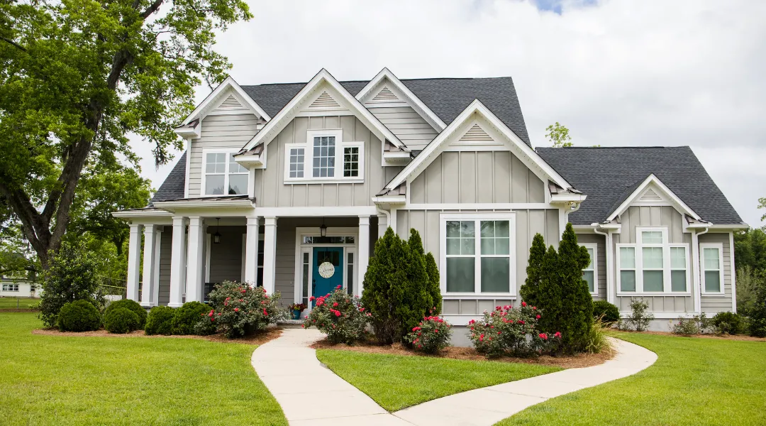 Newly built two-story suburban home with attached garage and fresh sod landscaping.