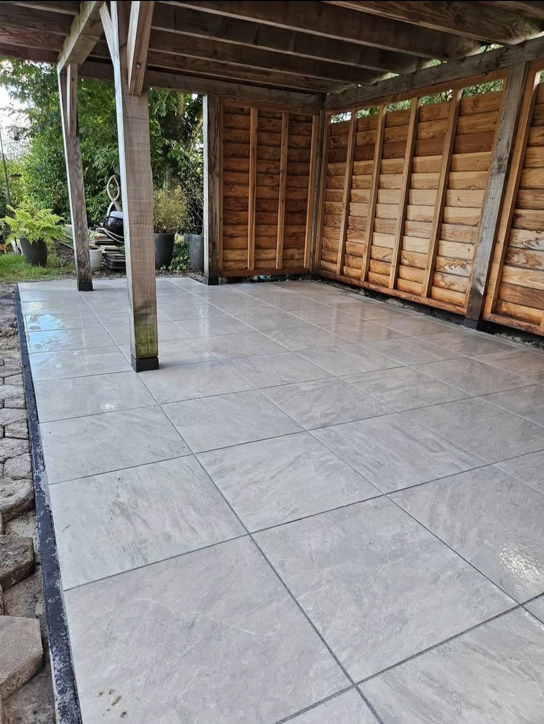 a man standing next to a pile of cages