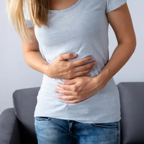 Hands on abdomen illustrating bloating, digestion and gut health