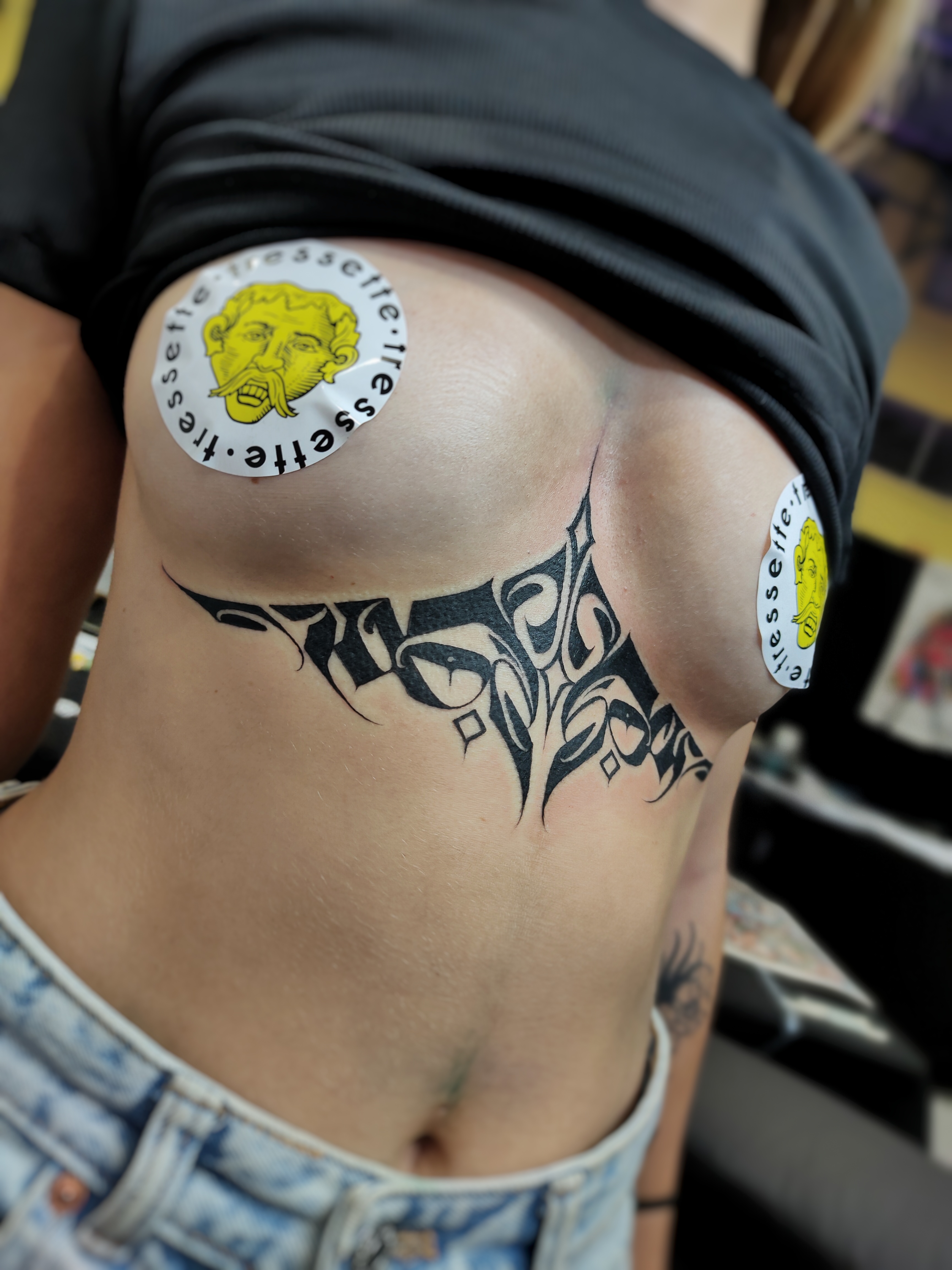 person in blue denim shorts and white nike sneakers standing on gray concrete floor