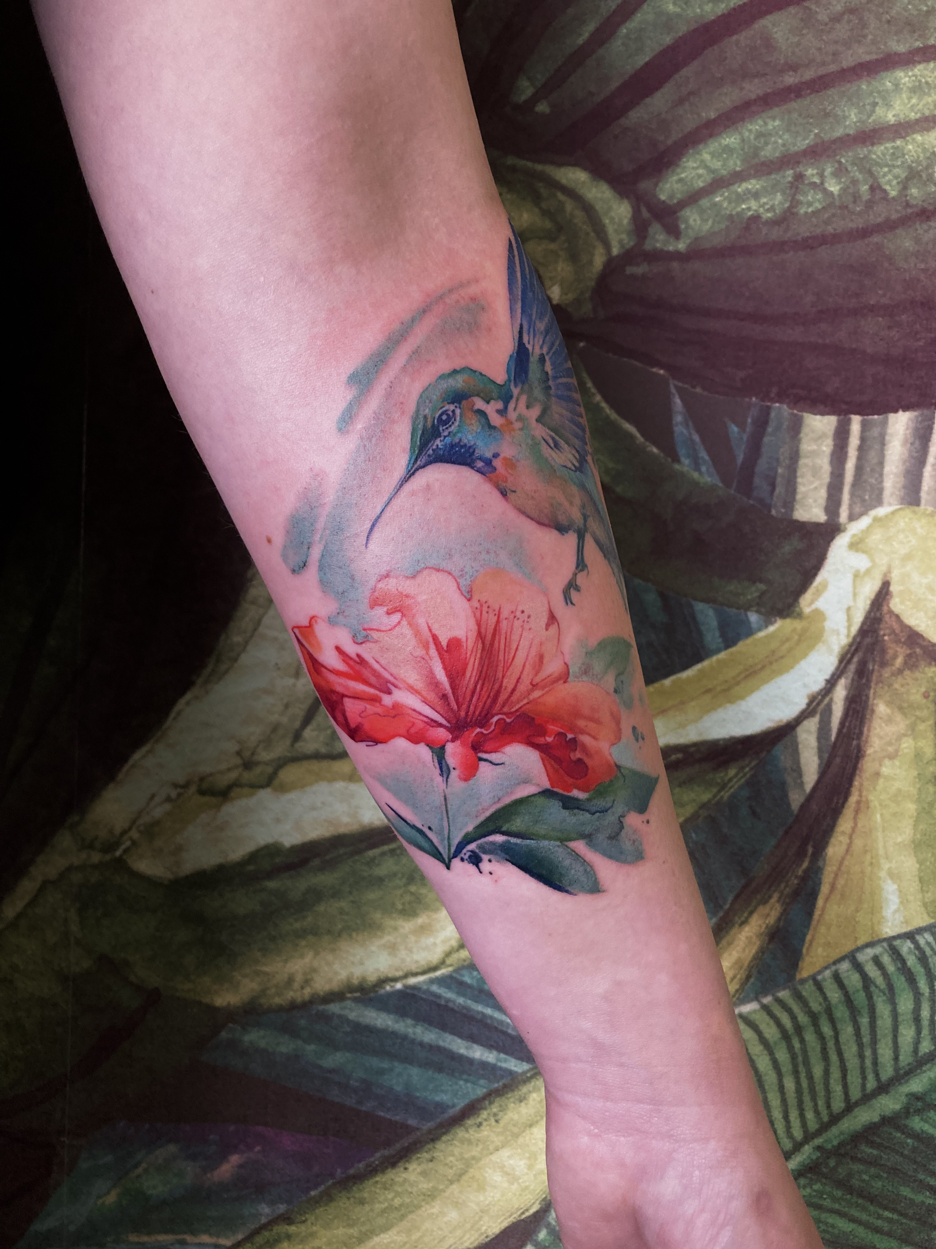 person in blue denim shorts and white nike sneakers standing on gray concrete floor