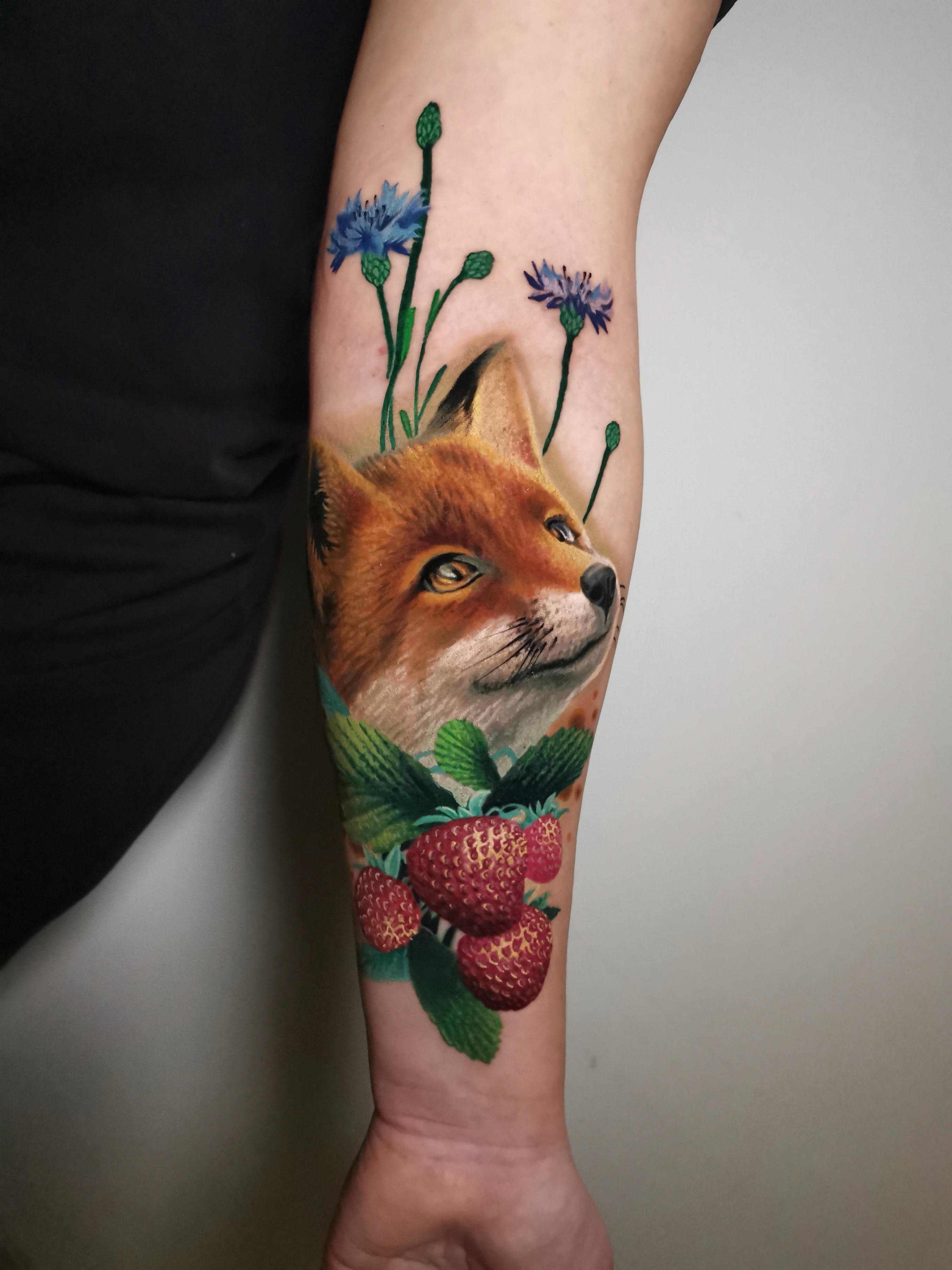 person with tattoo on right arm