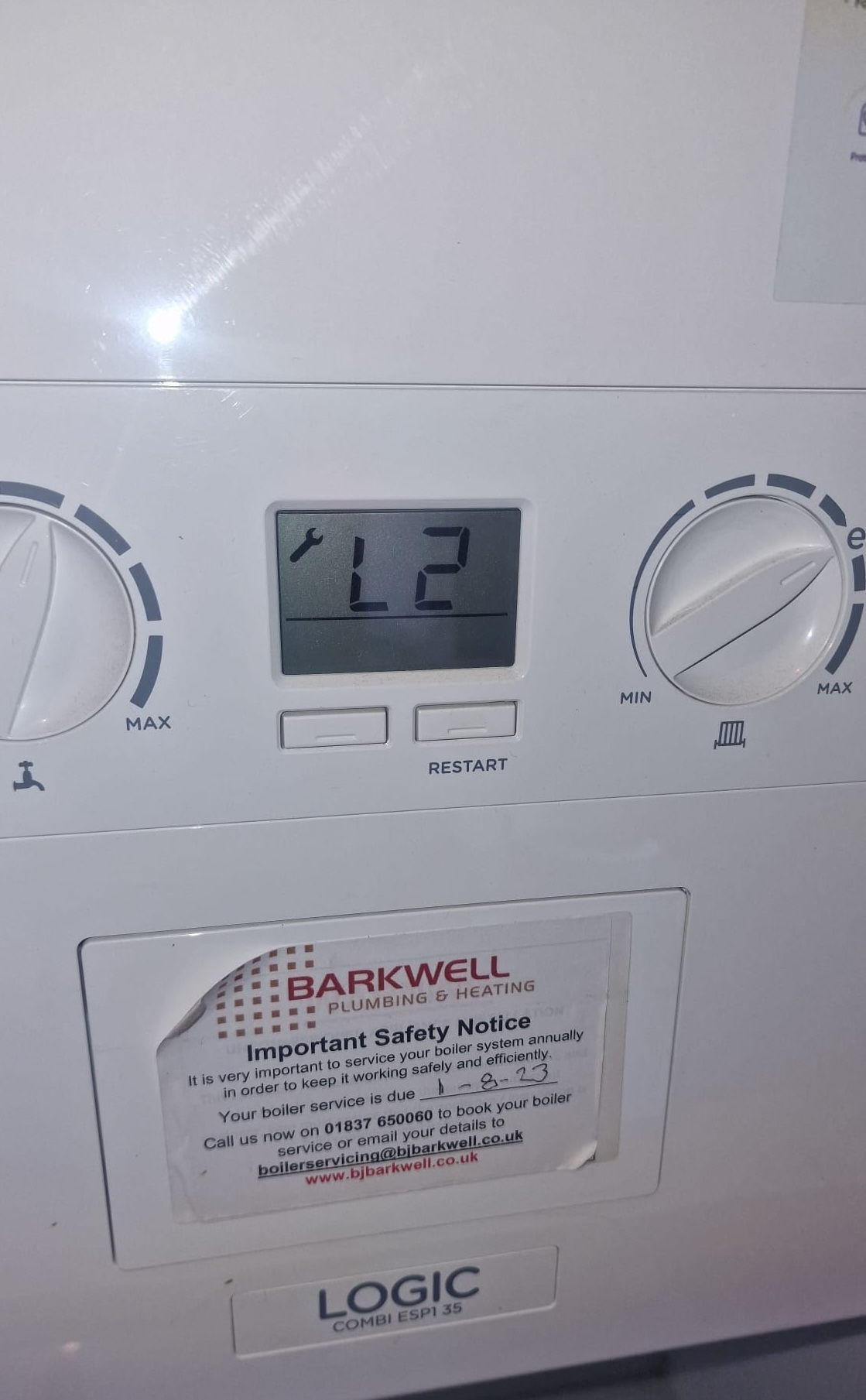 Heating engineer diagnosing an Ideal Logic combi boiler displaying an L2 ignition lockout fault code in Plymouth