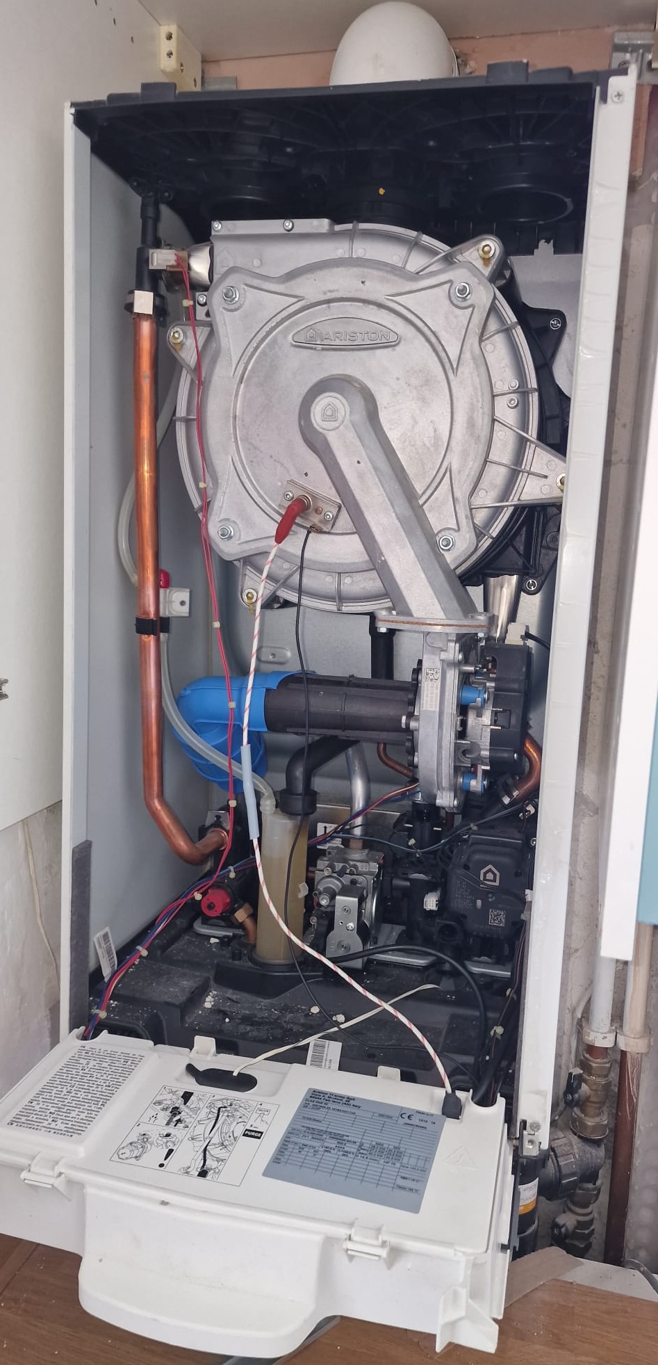Gas Safe engineer carrying out an annual service on an Ariston condensing boiler heat exchanger in Plymouth