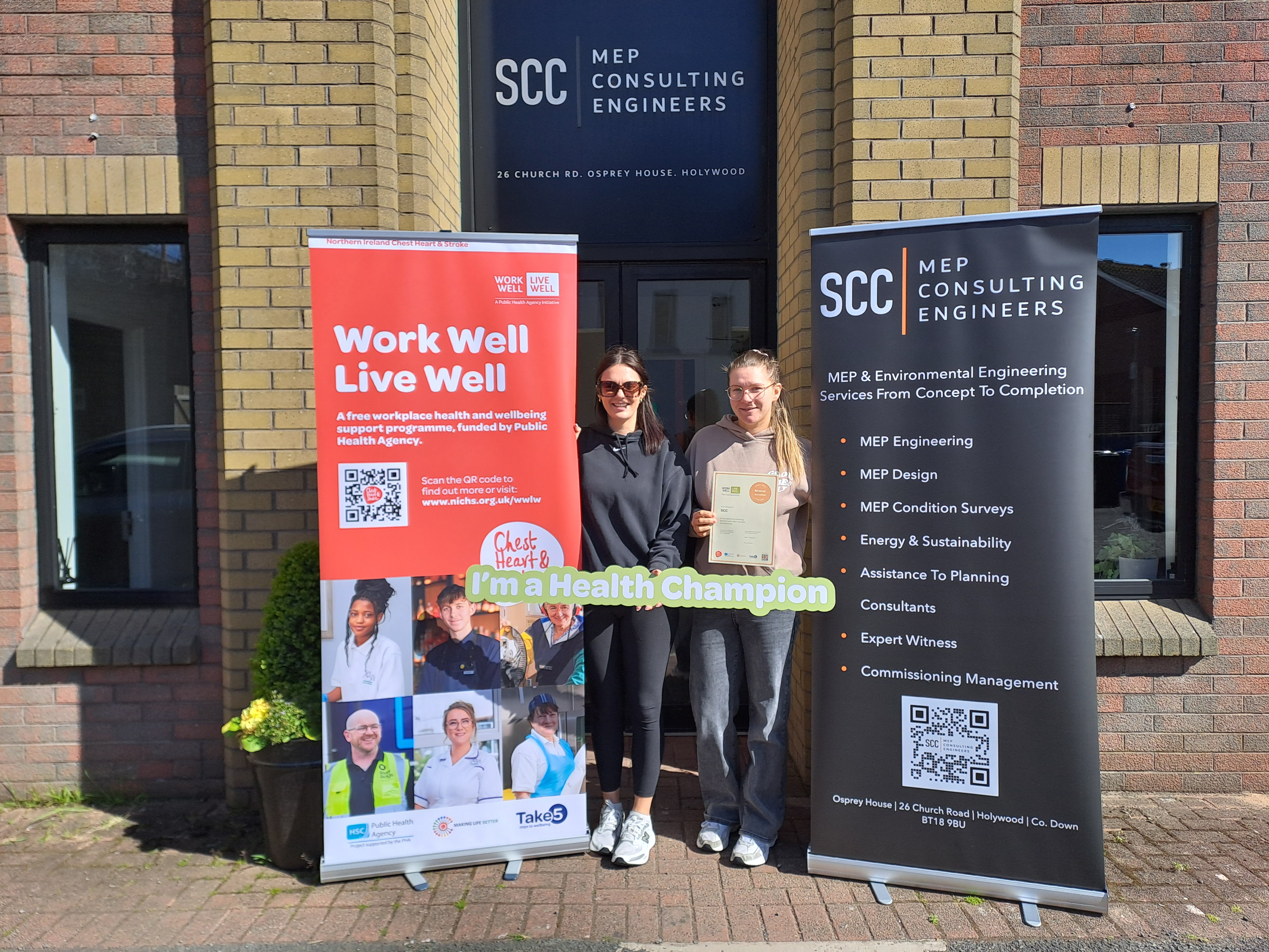 SCCMEP staff celebrating Bronze Work Well Live Well Accreditation outside the office