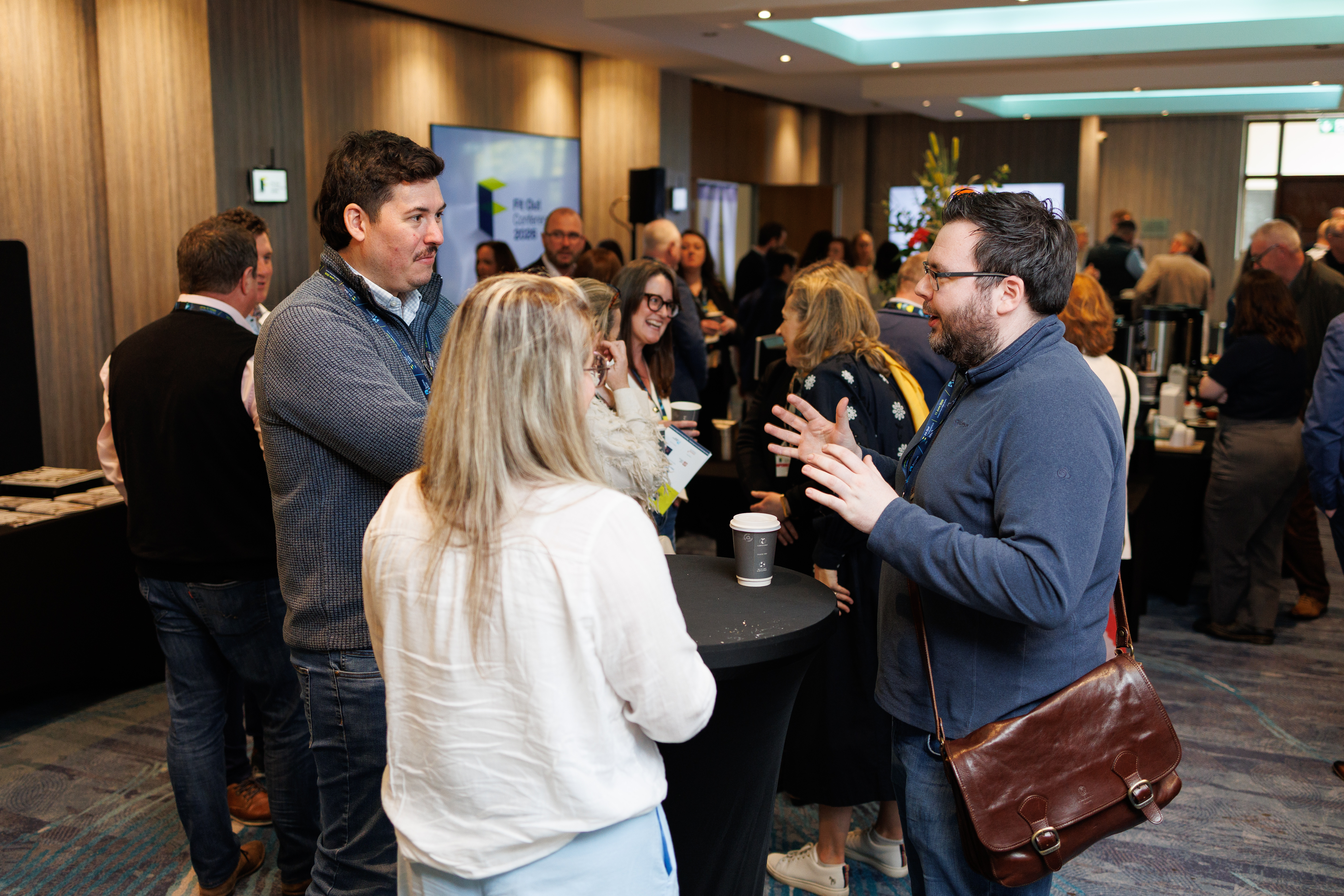 Attendees networking during the Fit Out Conference 2026 at Crowne Plaza Santry, discussing workplace design and industry trends.
