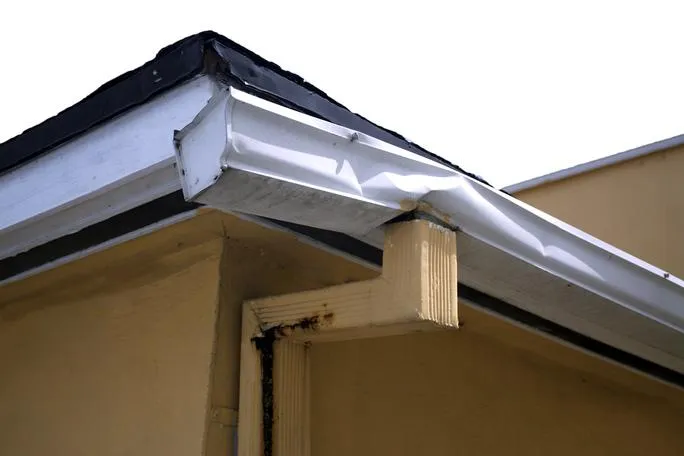Damaged and crushed commercial gutter system