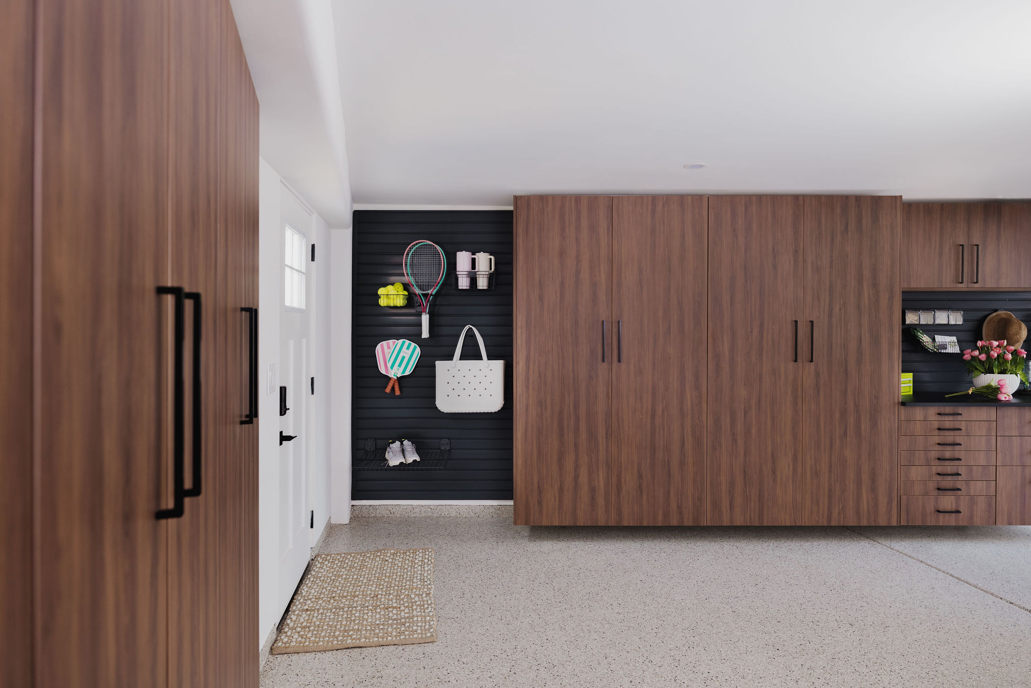 Custom Tahoe finish garage storage cabinets with modern black vertical handles