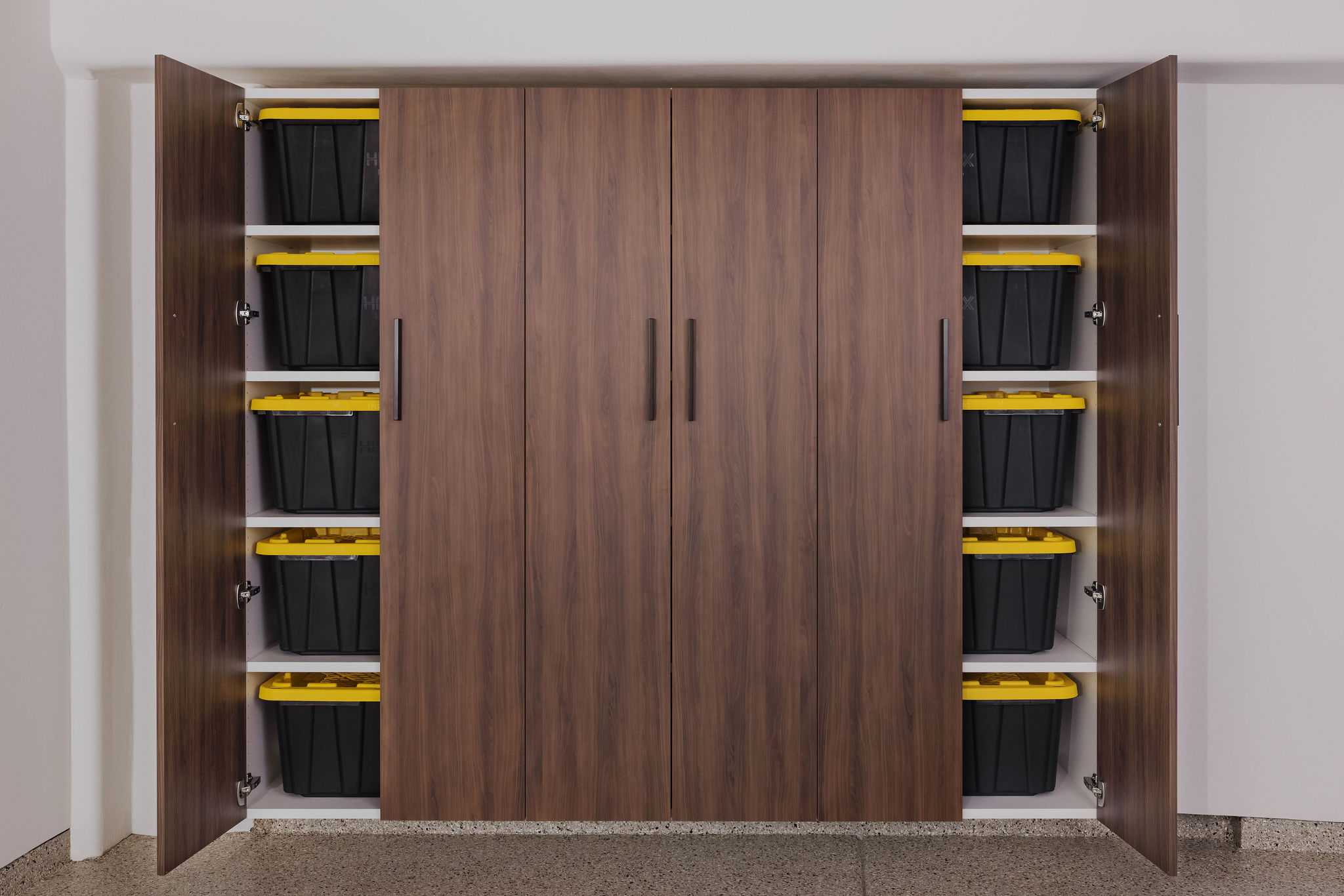 Tall garage storage closets with small interior shelves for tool organization