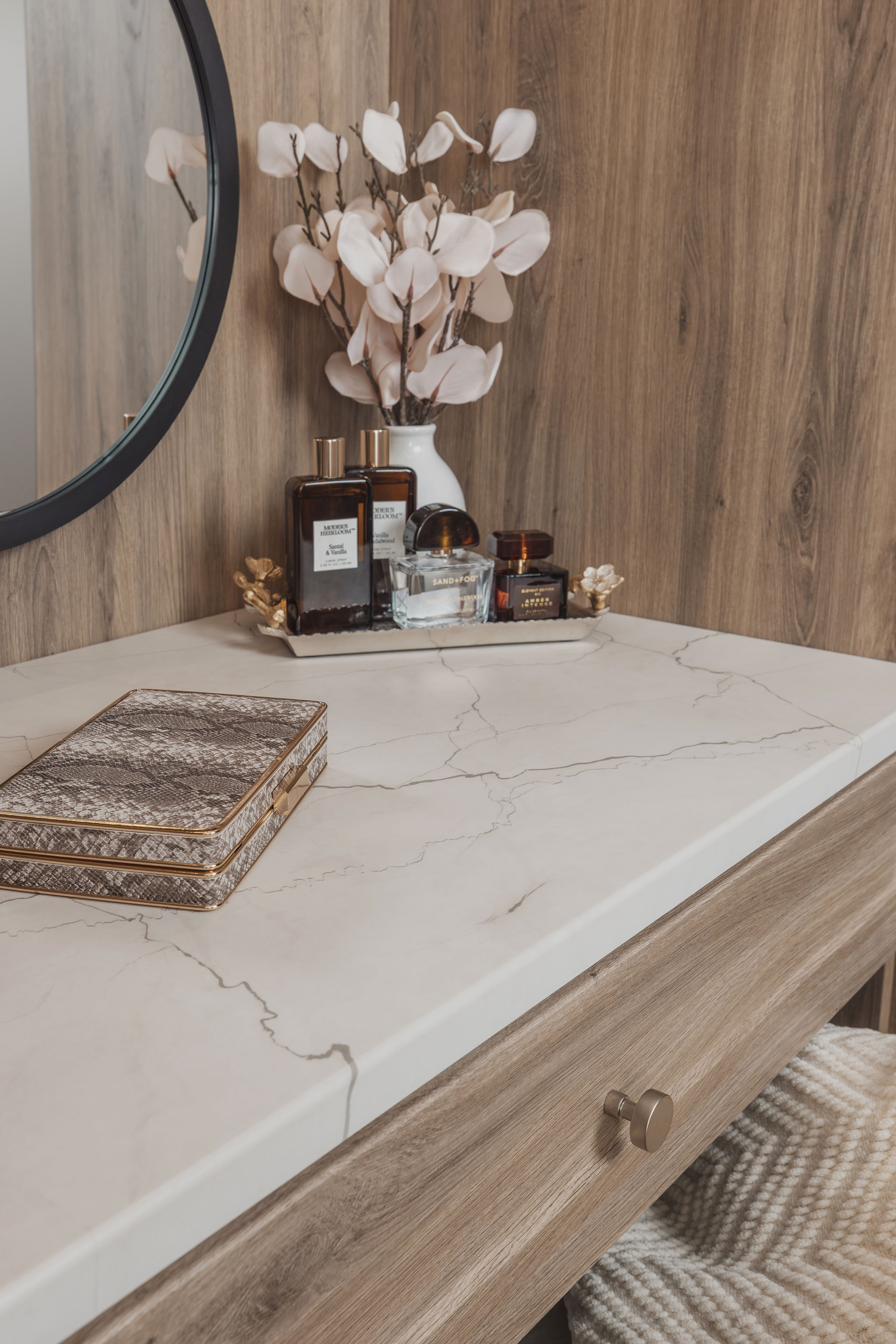 Luxury custom closet vanity featuring a marble countertop and decorative accessories