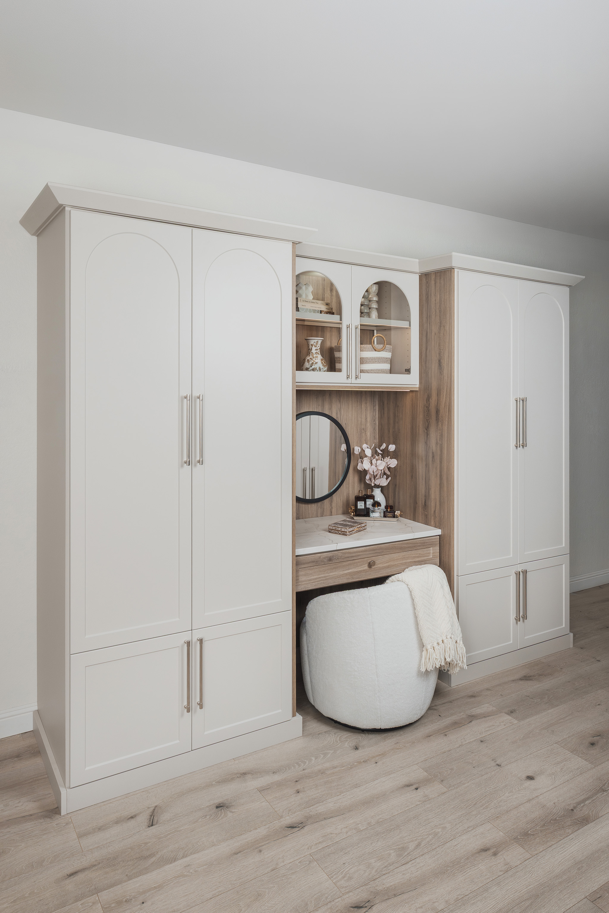 Built in bedroom cabinetry blending minimalist white doors with textured wood accents