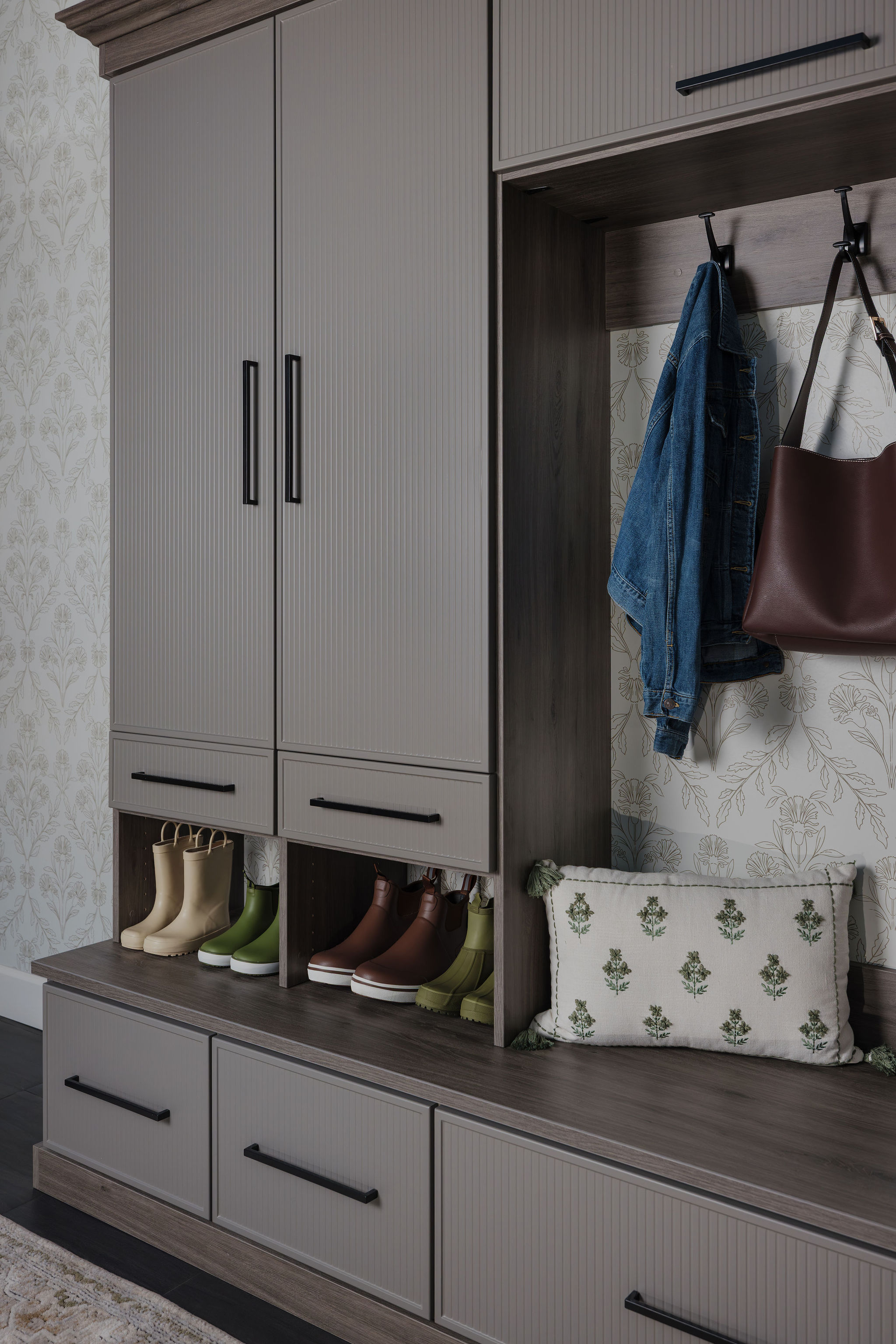 Bespoke entryway drop zone with falcon gray cabinets and open shoe storage shelves
