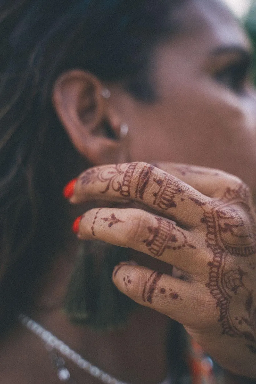 woman holding her hand to her ear with nice nails