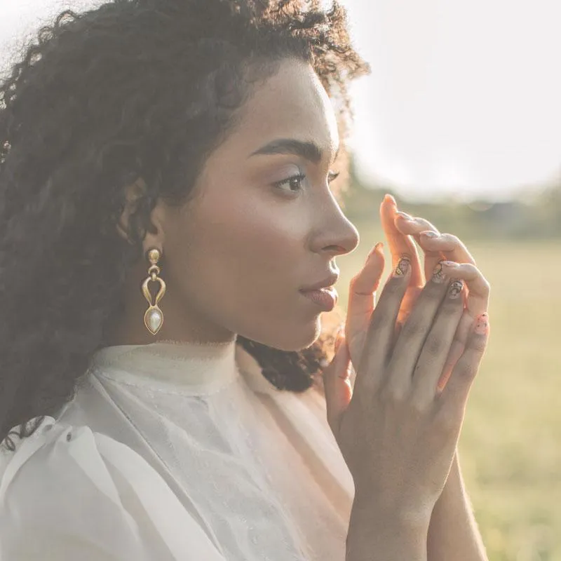 woman holding her hands up to her face outside