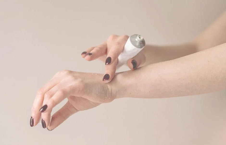 applying moisturizer to hand
