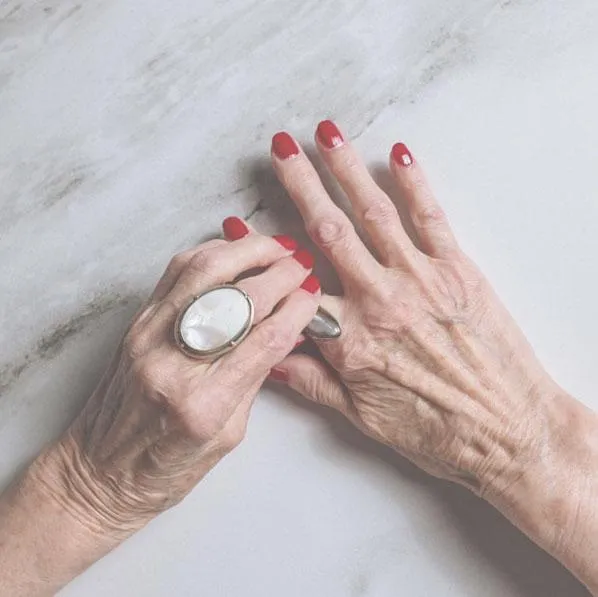 woman adjusting her rings with nice nails 