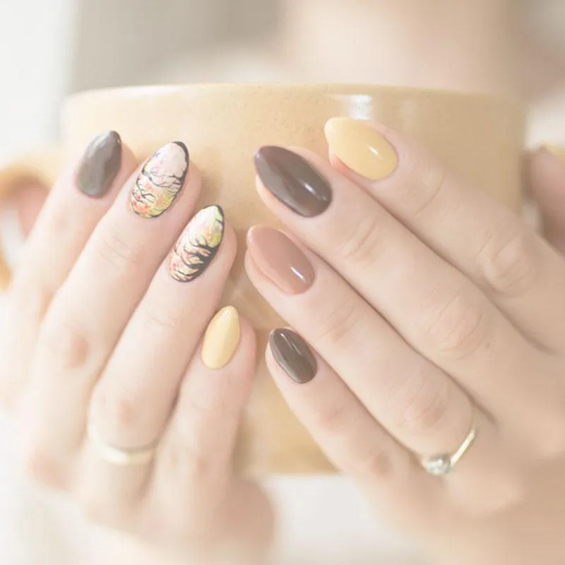 woman holding a coffee cup with beautiful nails 
