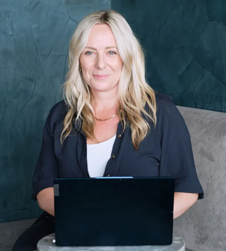 a man standing on a beach looking at the ocean