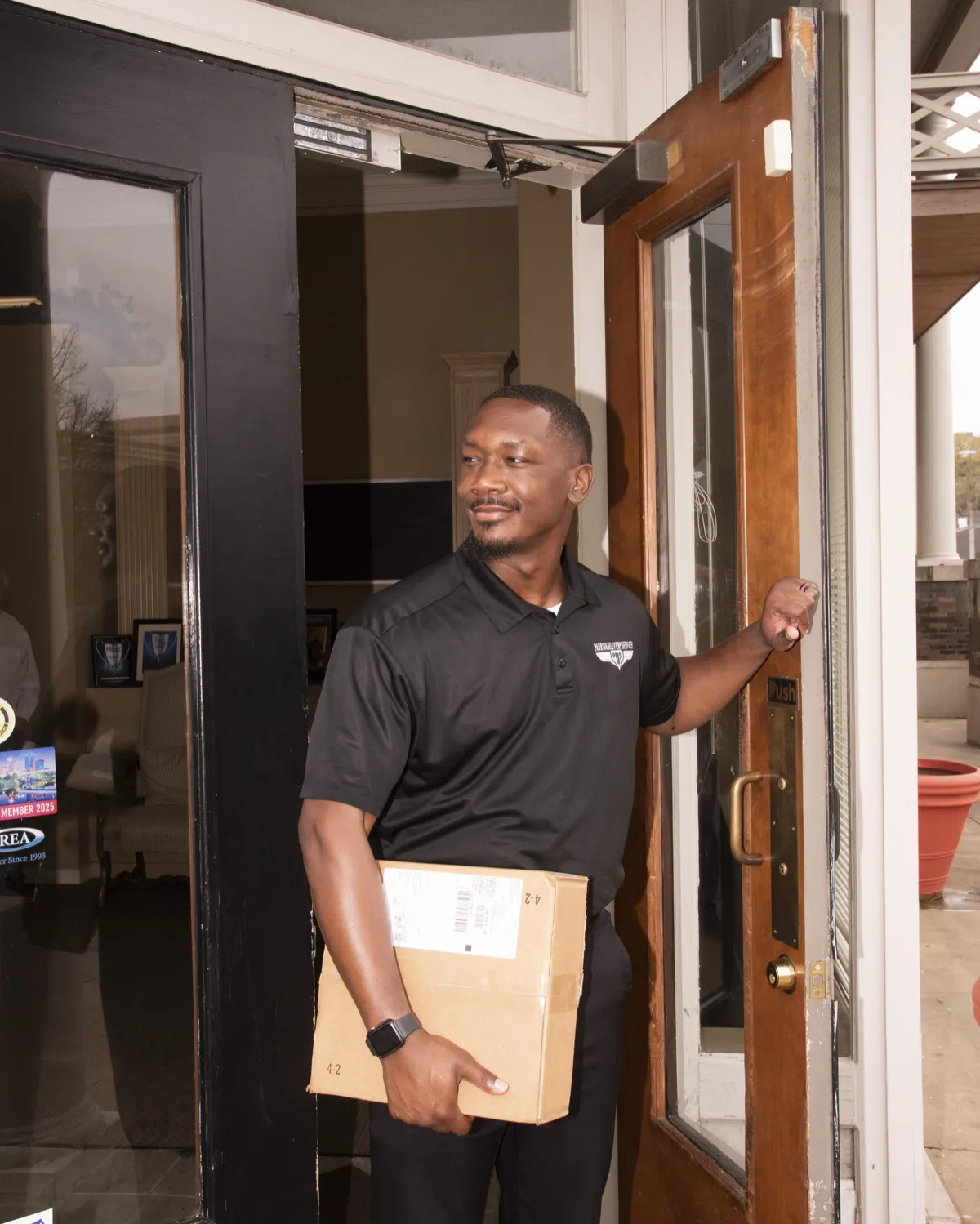 Professional Parrish Delivery Services courier in uniform with official badge