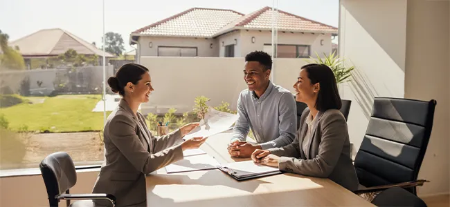 An image of a conveyancer having a meeting with their clients in a boardroom