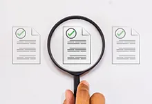 An image of a magnifying glass highlighting a document