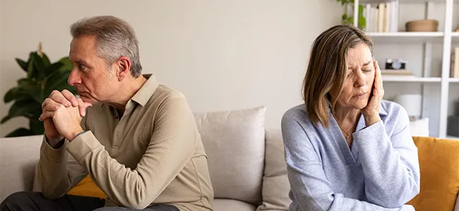 An image of a couple that are unhappy and do not want to speak to each other anymore.