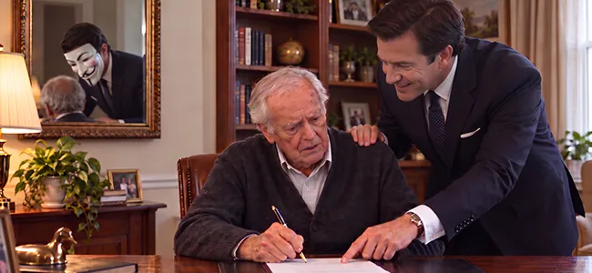An image of a legal professional showing a old man where to sign a legal document