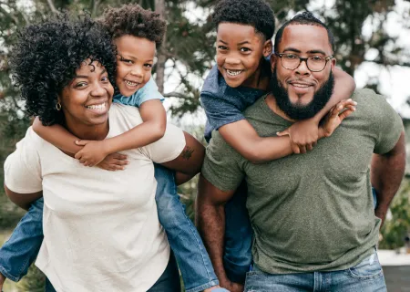 A multigenerational family, including grandparents, parents, and children, preparing a meal together in a bright kitchen. Everyone is smiling, chopping vegetables, and sharing stories, creating a lively and joyful atmosphere.