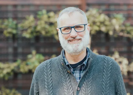 Parents carrying young children on their backs. Everyone is smiling. | Busy Family | Strengthen Communication | Reignite Connection | Marriage Coach