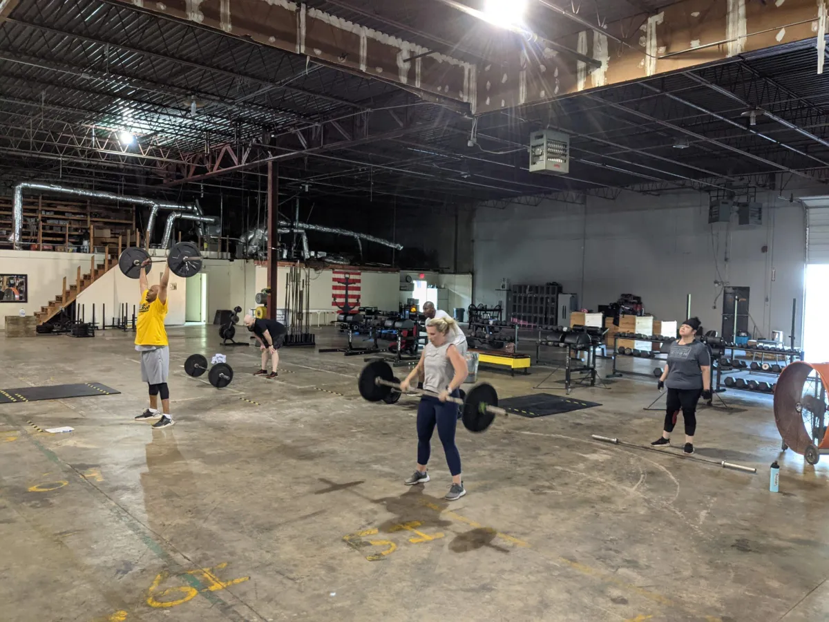 Group training session in the warehouse-style Fit 901 gym environment in Memphis