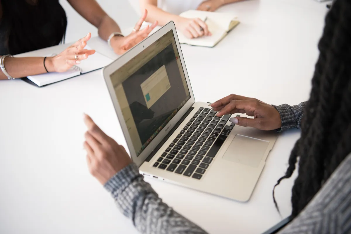 man operating laptop on top of table