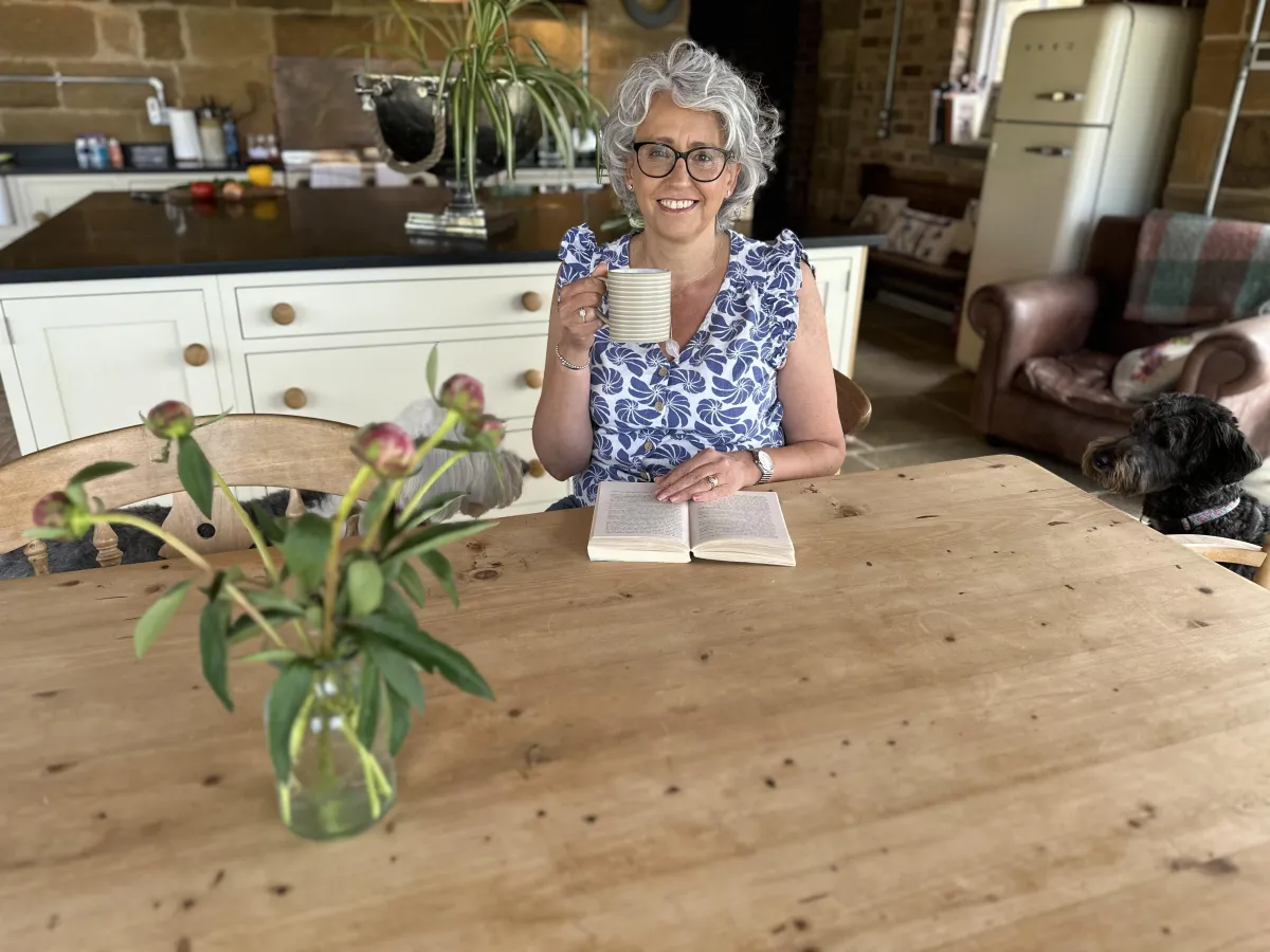 Lisa relaxing with book and cuppa