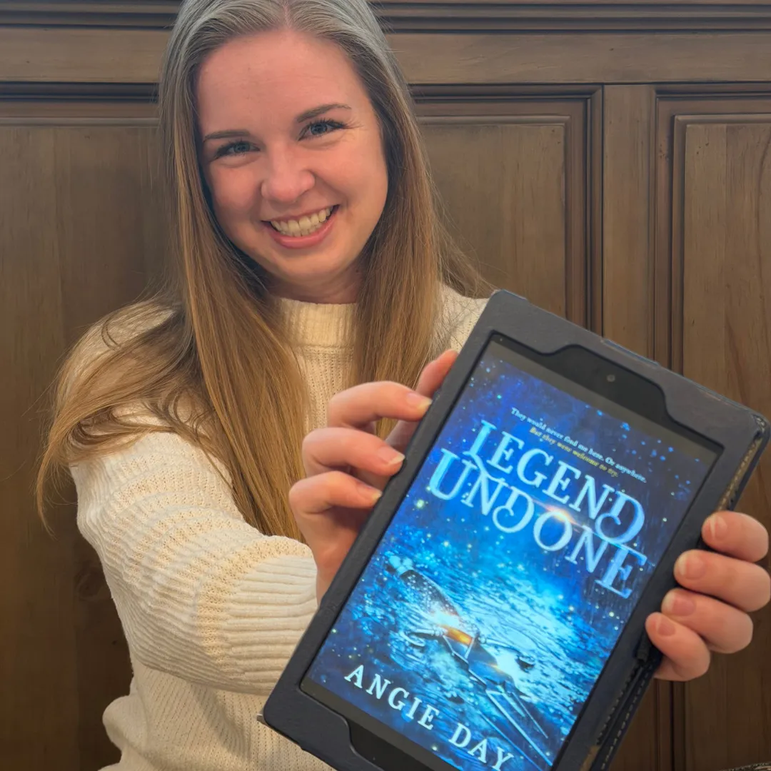 Happy reader holding Legend Undone fantasy romance ebook on tablet review photo