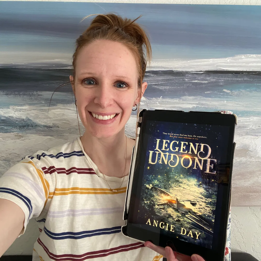 Reader smiling with Legend Undone clean fantasy romance ebook on Kindle device