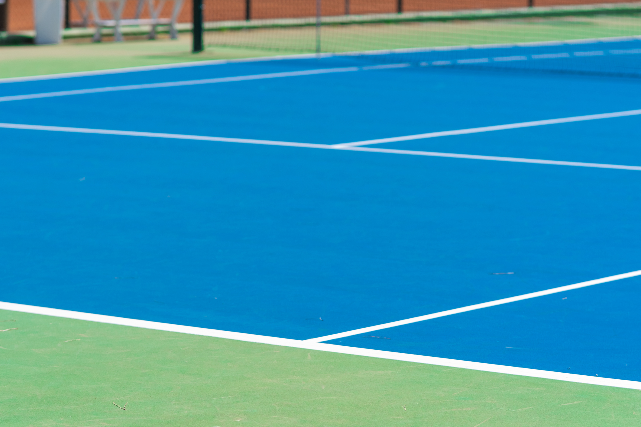 Tennis court repaint and resurface project with clean lines