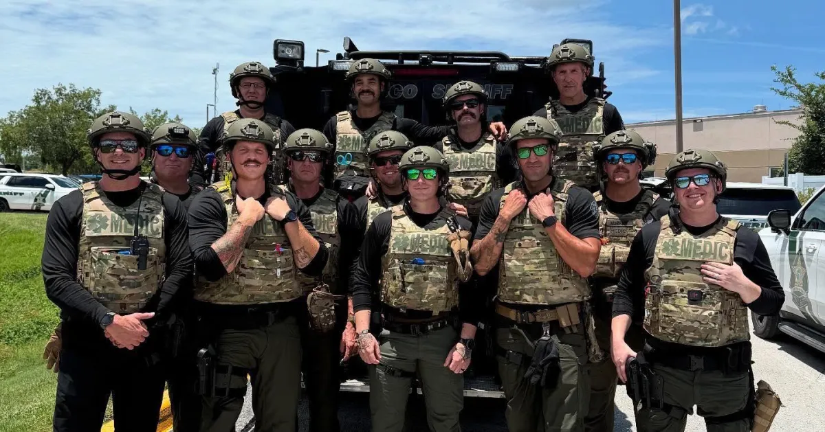 Pasco County Professional Firefighters assigned to tactical medic unit posing in full gear during joint training with law enforcement