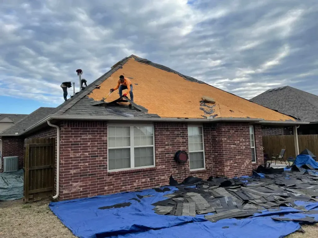 a couple of men standing on top of a roof