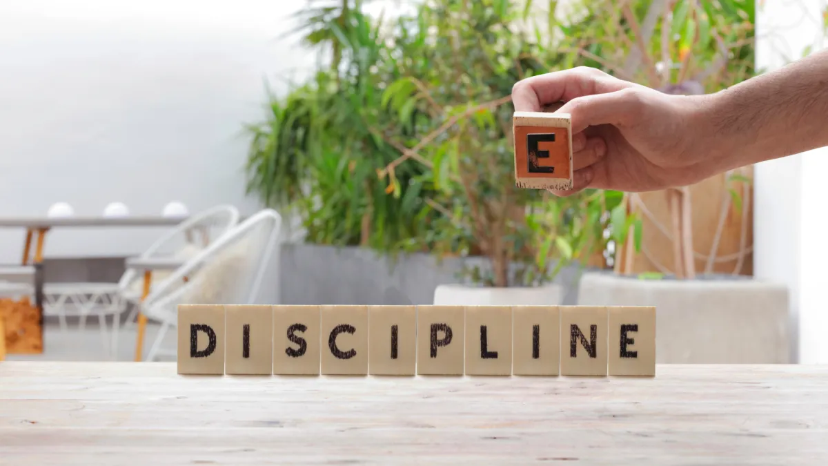Wooden blocks spelling discipline representing consistent health habits and long-term wellness at Excelsior Health Centers in Chesterfield MO