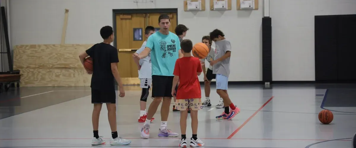 Youth basketball team warming up during indoor practice