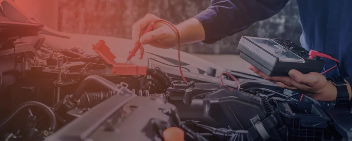 Technician testing an engine with a multimeter