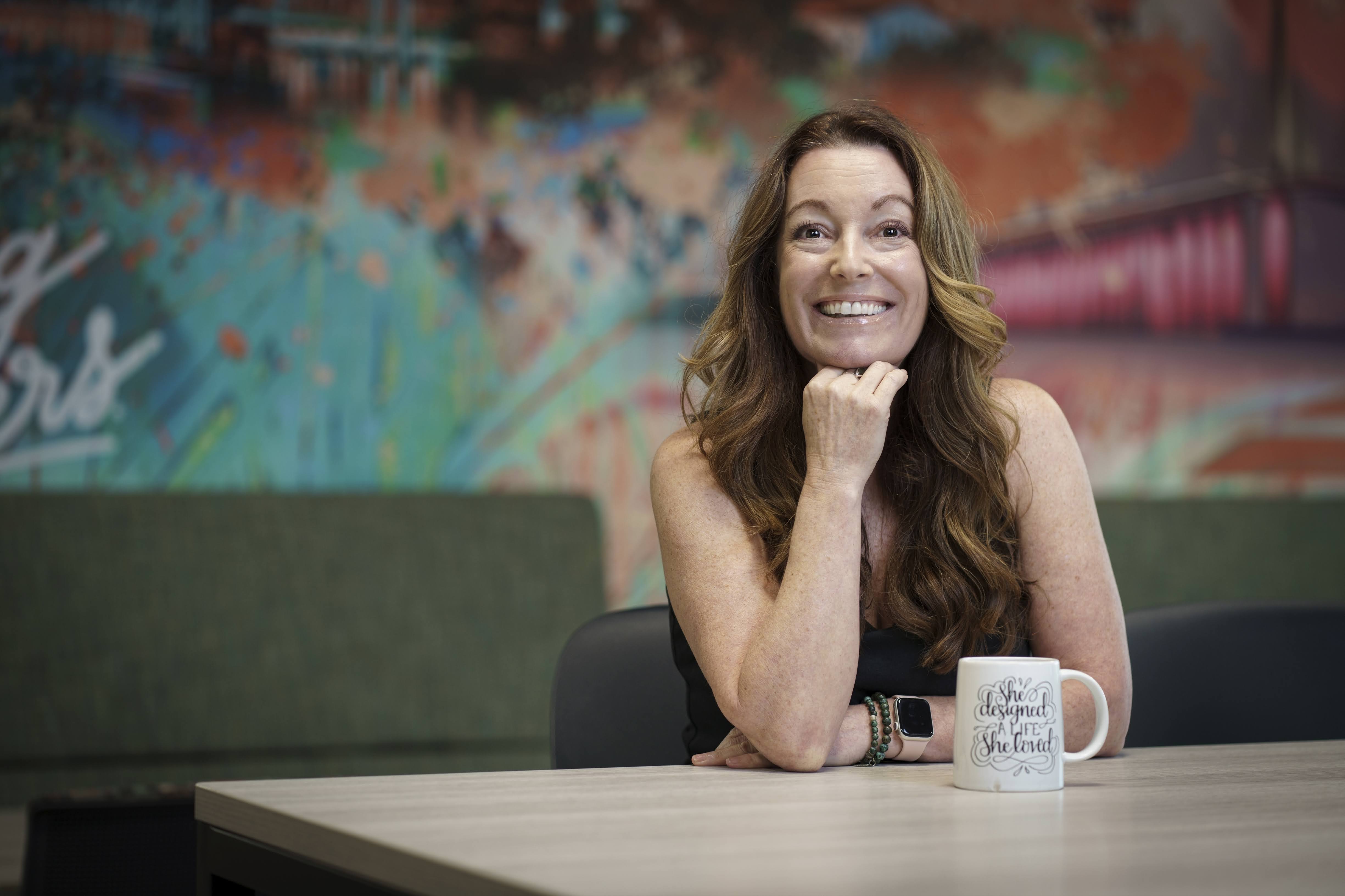 image of a woman smiling while standing