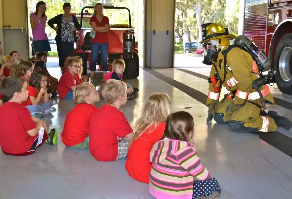 man in yellow and black camouflage jacket walking on street during daytime