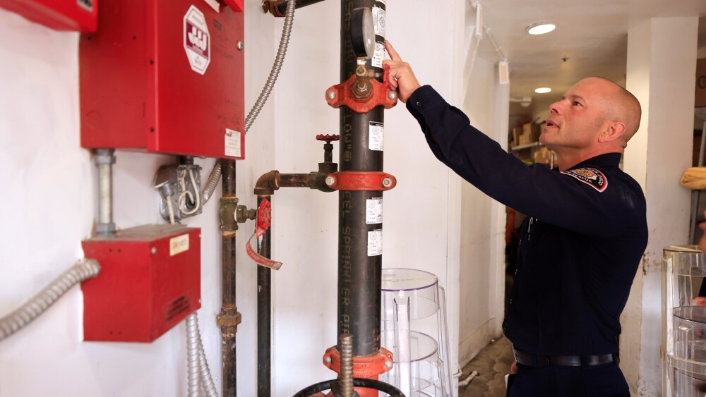 Firefighters are putting out a fire with water.